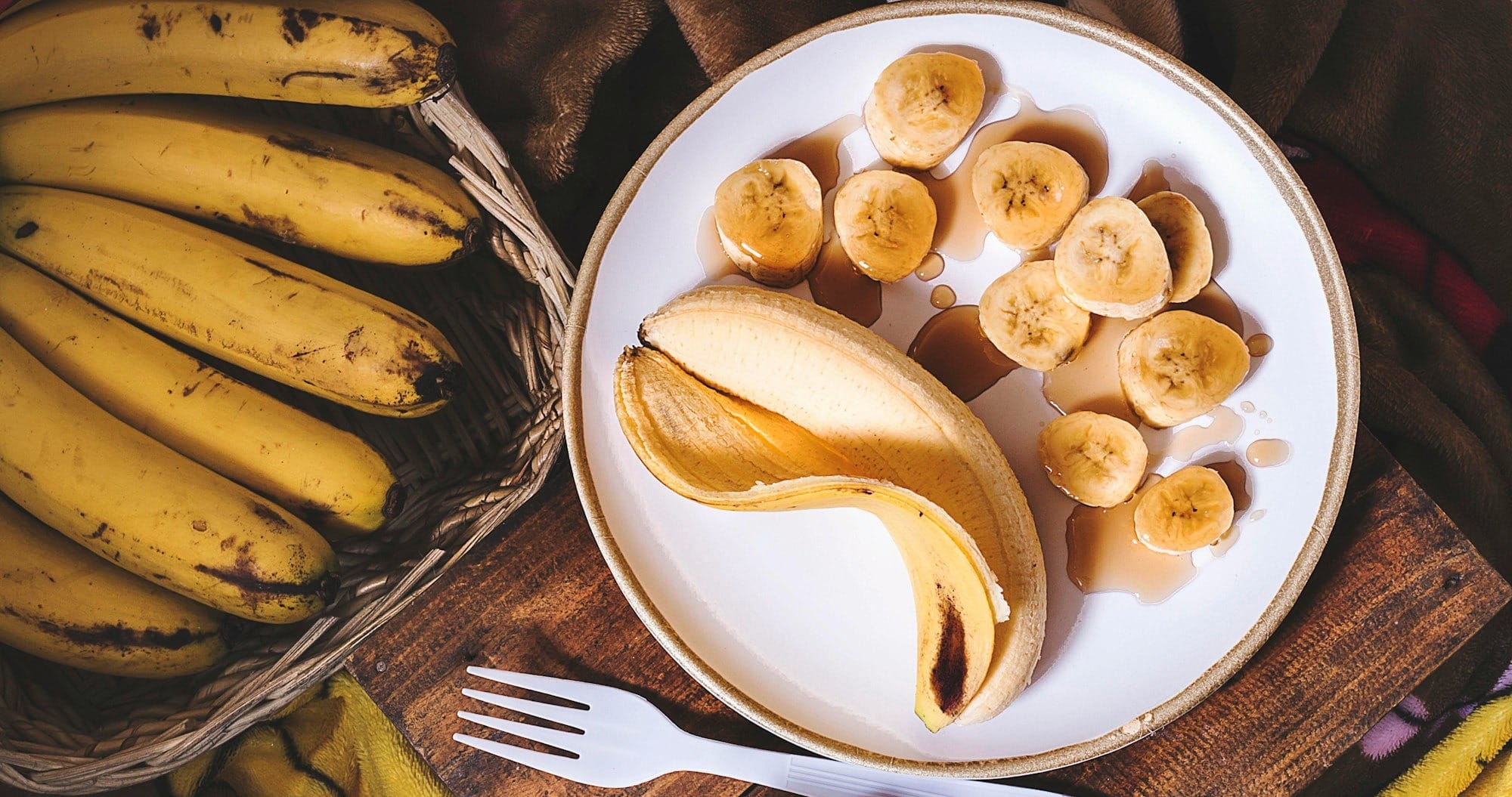 sliced ripe banana on round white ceramic plate